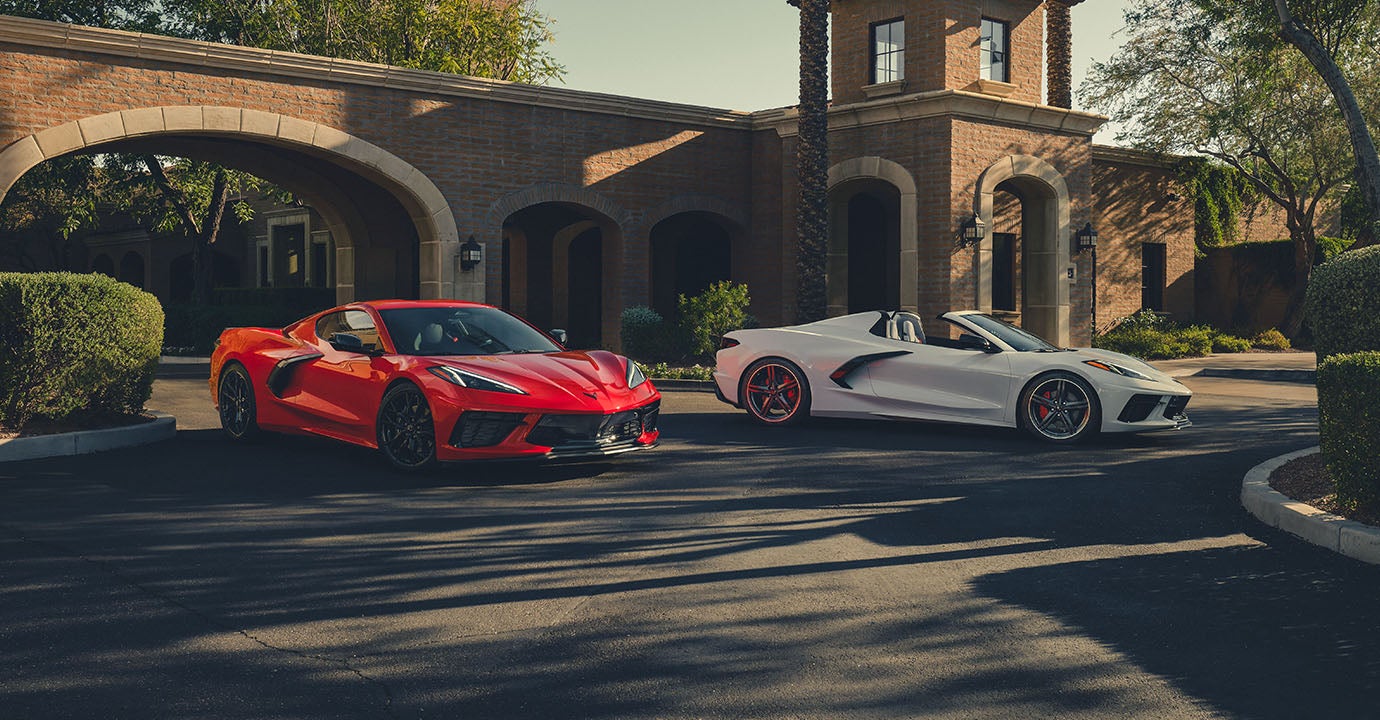 Corvette lined up in front of house.