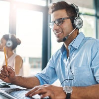 man on headset taking call in office