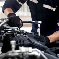 service technician working on car engine